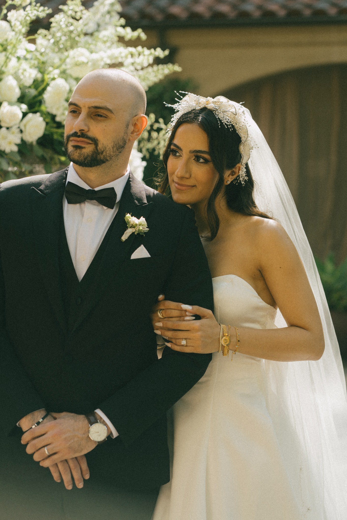 A bride and groom together in a sunlit garden