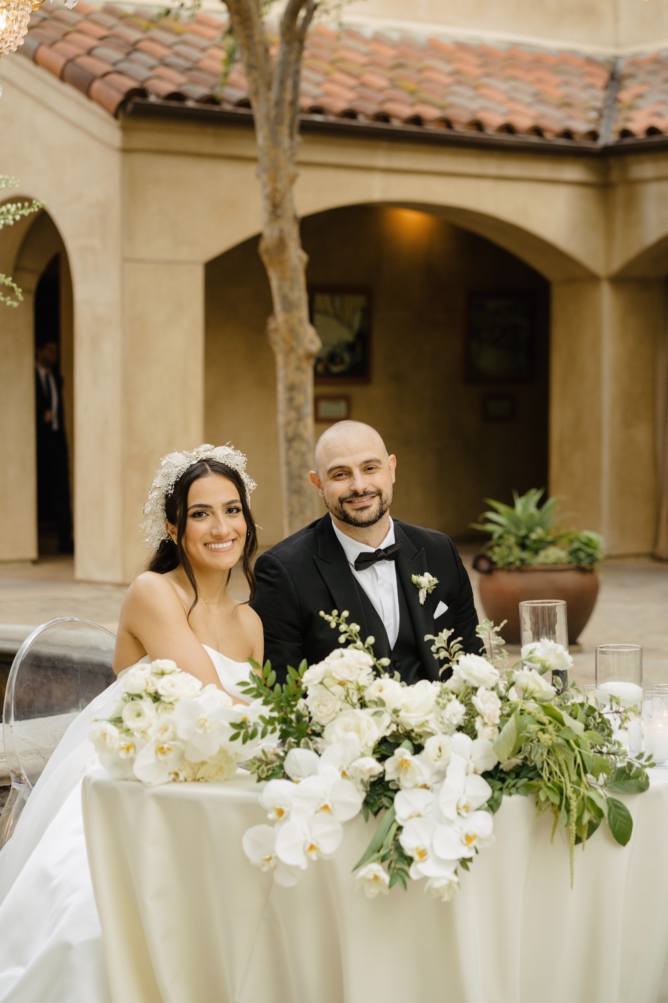 The couple at a flower-filled courtyard reception